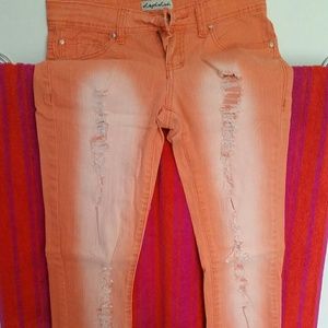 Bright orange distressed skinny jeans